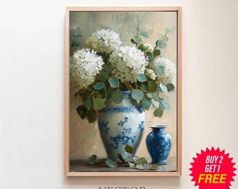 May include: A painting of a white hydrangea bouquet in a blue and white porcelain vase with a smaller blue vase next to it. The painting is framed in a light wood frame.