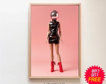 May include: A framed print of a doll with a disco ball for a head, wearing a black leather dress and red boots, standing on a pink background. The text "VECTOR ART STUDIO" is below the image.