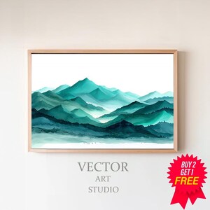 May include: Watercolor painting of a mountain range in shades of teal and green, framed in a light wood. The artwork features layers of peaks and valleys, with the text "VECTOR ART STUDIO" at the bottom. A red starburst graphic says "BUY 2 GET 1 FREE".