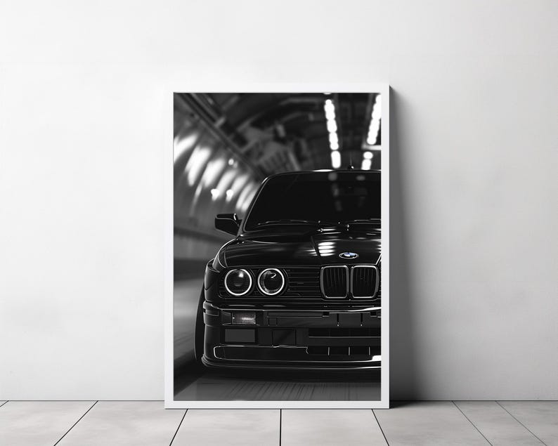 May include: A black and white photograph of a black BMW E30 driving through a tunnel. The car is in focus, and the tunnel is blurred in the background.