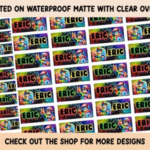 May include: A sheet of colorful stickers with a space-themed design. The stickers feature a cartoon character with a red hat and sunglasses, holding a video game controller. The text "ERIC" and "ROBLOX" are printed on the stickers.