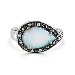 May include: A silver ring featuring a pear-shaped white opal gemstone set within a border of black marcasite stones.