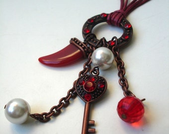 Charm  necklace in copper, red and white.