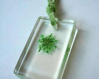 Resin pendant with real flower and lime green suede cord