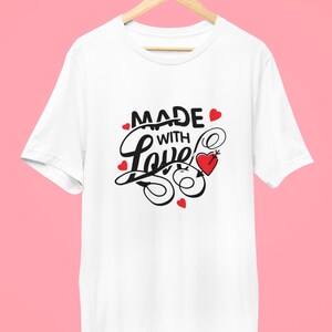 May include: White t-shirt with a black and red graphic that says "Made with Love" with a heart and a needle and thread.