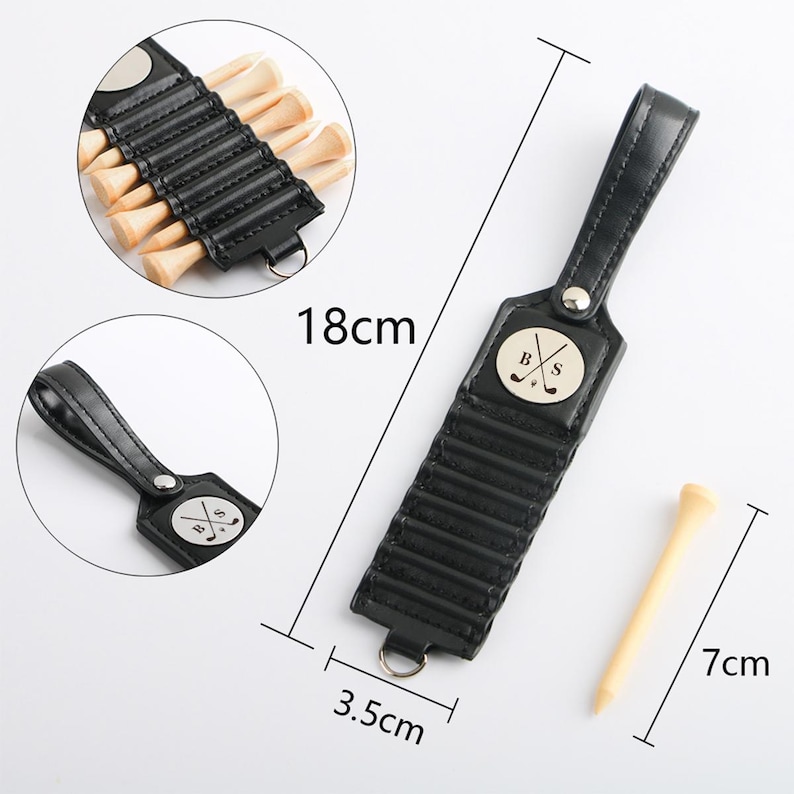 May include: A black leather golf tee holder with a handle, measuring 18cm long and 3.5cm wide, holds several wooden golf tees. A single tee, 7cm long, is shown separately. The holder features a metal emblem with the letters "B" and "S" crossed with a golf club.