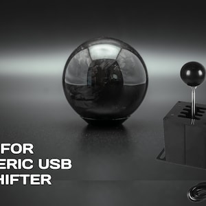 Könnte beinhalten: Schwarzer USB-Schalthebel mit schwarzem Knopf und schwarzem Sockel. Der Schalthebel hat ein Kabel. Der Text "FOR GENERIC USB SHIFTER" ist im Bild sichtbar.