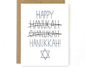 May include: A white card with the text "HAPPY HANUKKAH!" in blue and black ink. The word "HANUKKAH" is written three times, with the first two spellings crossed out. A blue Star of David is at the bottom of the card.