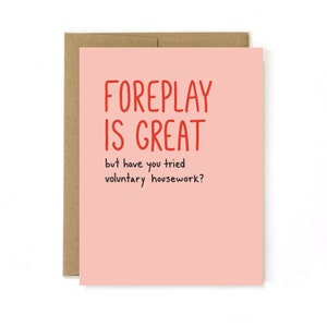 May include: A pink card with the text "FOREPLAY IS GREAT but have you tried voluntary housework?" in red and black lettering.