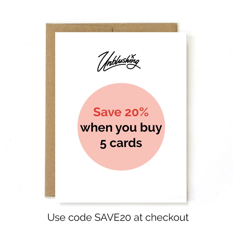 May include: A white card with a pink circle that says "Save 20% when you buy 5 cards". The text "Unblushing" is written in black cursive at the top of the card. The text "Use code SAVE20 at checkout" is written in black at the bottom of the card.