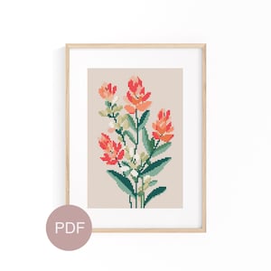 May include: A cross-stitch pattern featuring a bouquet of orange and pink flowers with green leaves. The pattern is framed in a light wood frame and labeled "PDF" in the bottom left corner.
