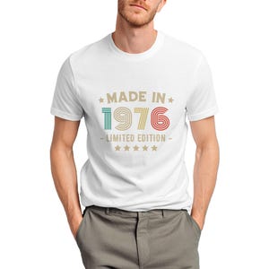 Puede incluir: Camiseta blanca con el texto "MADE IN 1976 - LIMITED EDITION" en un dise&ntilde;o retro. El texto es de varios colores, incluyendo verde, rojo y amarillo. La camiseta tiene cuello redondo y mangas cortas.