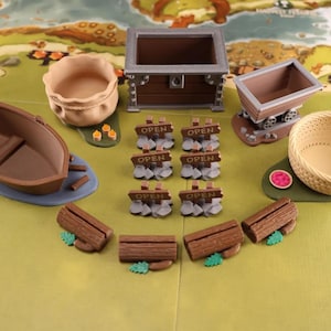 Empty Everdell resource holders on a game board: a pouch, boat, mine cart, berry basket and a coin chest. Also on the board there are 6 open signs and 4 log shaped event card holders.