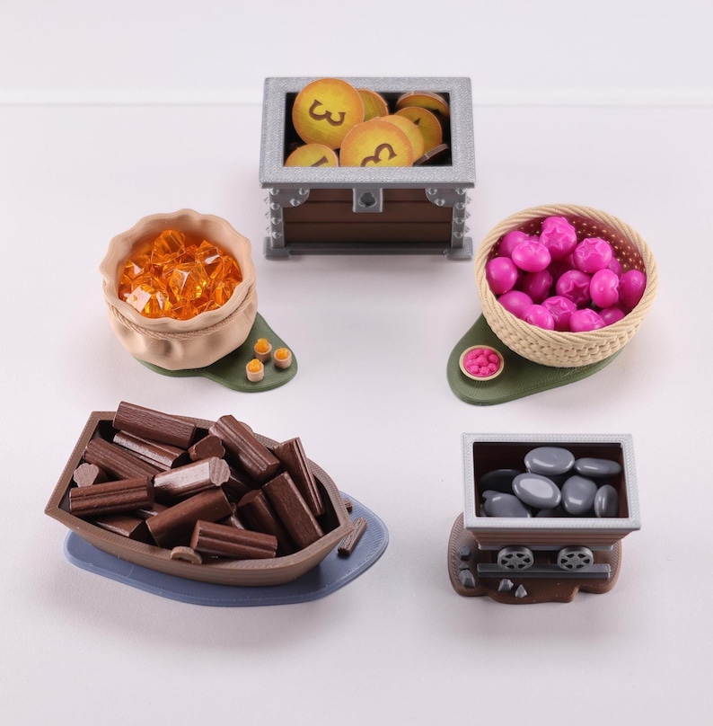 Everdell resource holders on a white background: a pouch, boat, mine cart, berry basket and a coin chest. The models have their respective tokens in them.
