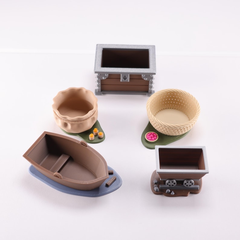 Everdell resource holders on a white background: a pouch, boat, mine cart, berry basket and a coin chest. The models are empty.