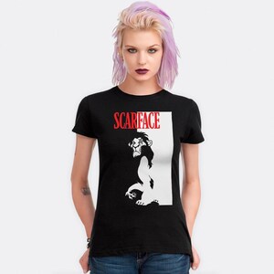 May include: Black t-shirt with a white silhouette of Scar from The Lion King. The text "SCARFACE" is in red letters above the lion.