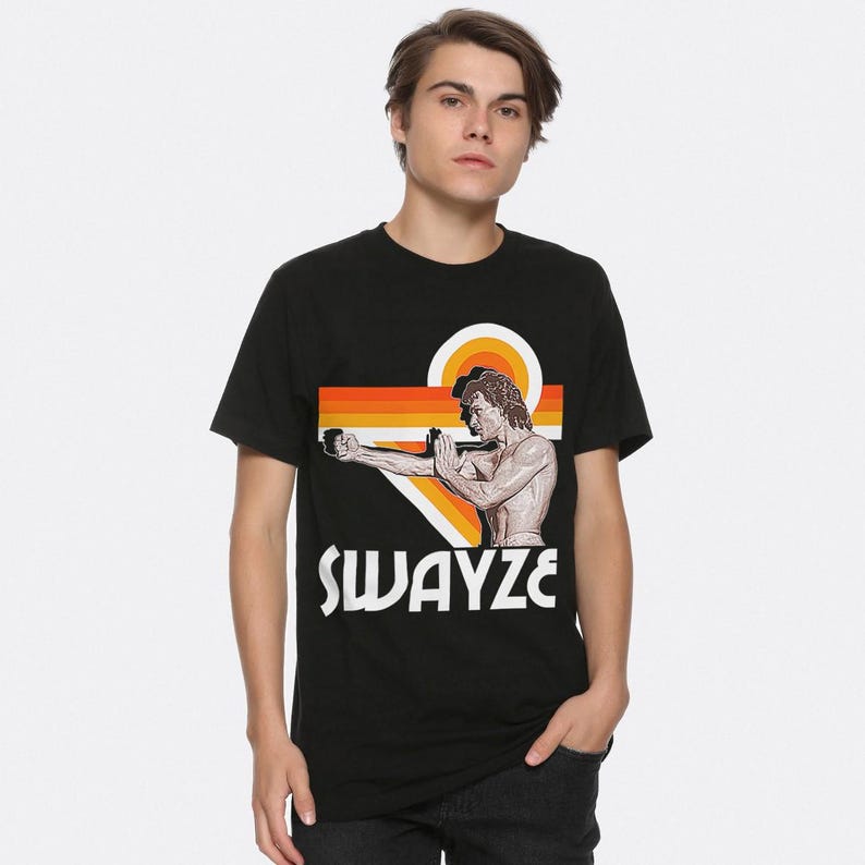 May include: Black t-shirt with a retro graphic of Patrick Swayze in a karate pose with the text "SWAYZE" underneath.