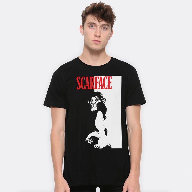 May include: Black t-shirt with a white and black image of Scar from The Lion King. The text "SCARFACE" is printed in red above the image.