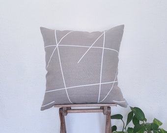 Beige and white pillow cover made of linen and white details from the Mikado series