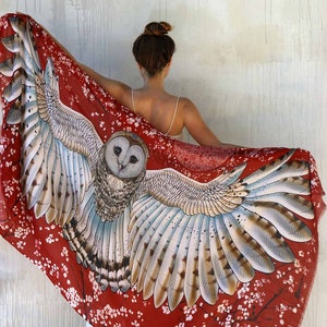 Soft shawl with owl wings made from cashmere in red color.