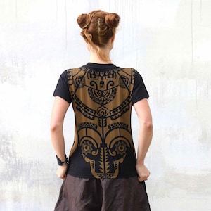 May include: Black t-shirt with a brown geometric pattern on the back. The pattern is reminiscent of a tribal design.