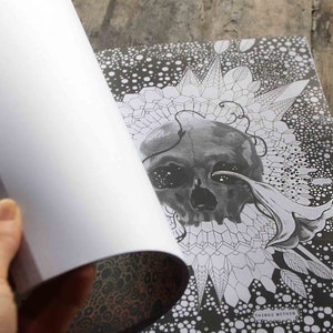 K&ouml;nnte beinhalten: Eine Schwarzwei&szlig;illustration eines Sch&auml;dels mit einer Blume und geometrischen Mustern. Der Text "Things Within" ist unten im Bild sichtbar.