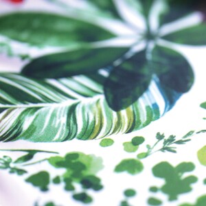 May include: White fabric with a green tropical leaf pattern. The leaves are in various shades of green and have a watercolor effect.