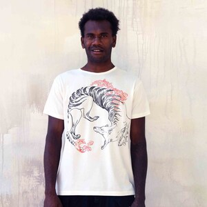 May include: A white t-shirt featuring a black and white graphic print of a stylised animal with red floral accents.