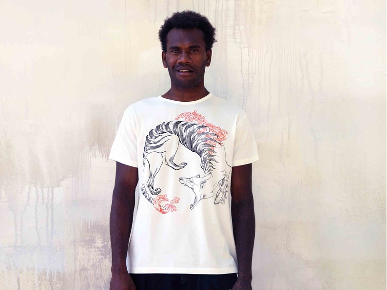 May include: A white t-shirt featuring a black and white graphic print of a stylised animal with red floral accents.