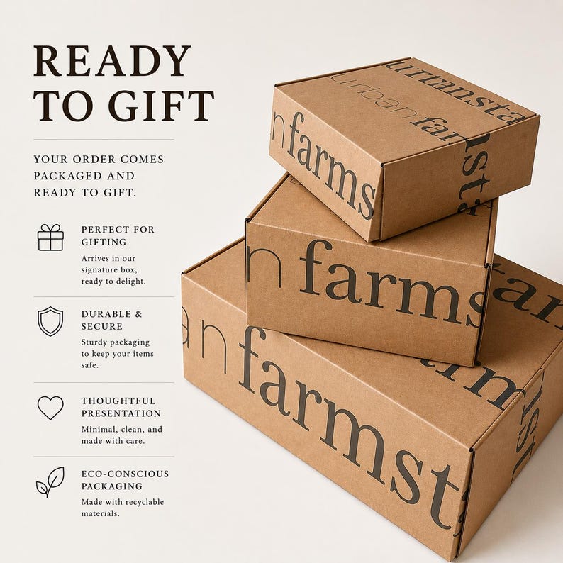 May include: Three stacked, brown cardboard boxes with the words "urban farms" printed in black. The boxes are ready to gift and packaged securely. The text "READY TO GIFT" is at the top left.
