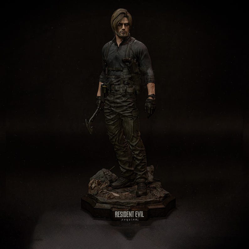 May include: A detailed figurine of a character from Resident Evil, dressed in a black tactical outfit and holding a weapon. The figure stands on a rocky base with the game's title, "Resident Evil Requiem," inscribed.