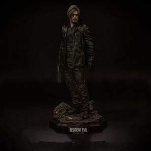 May include: A detailed figurine of a man in a black leather jacket and pants, holding a gun. The figure stands on a rocky base with the text "RESIDENT EVIL requiem". The overall color palette is dark, with a focus on texture and detail.