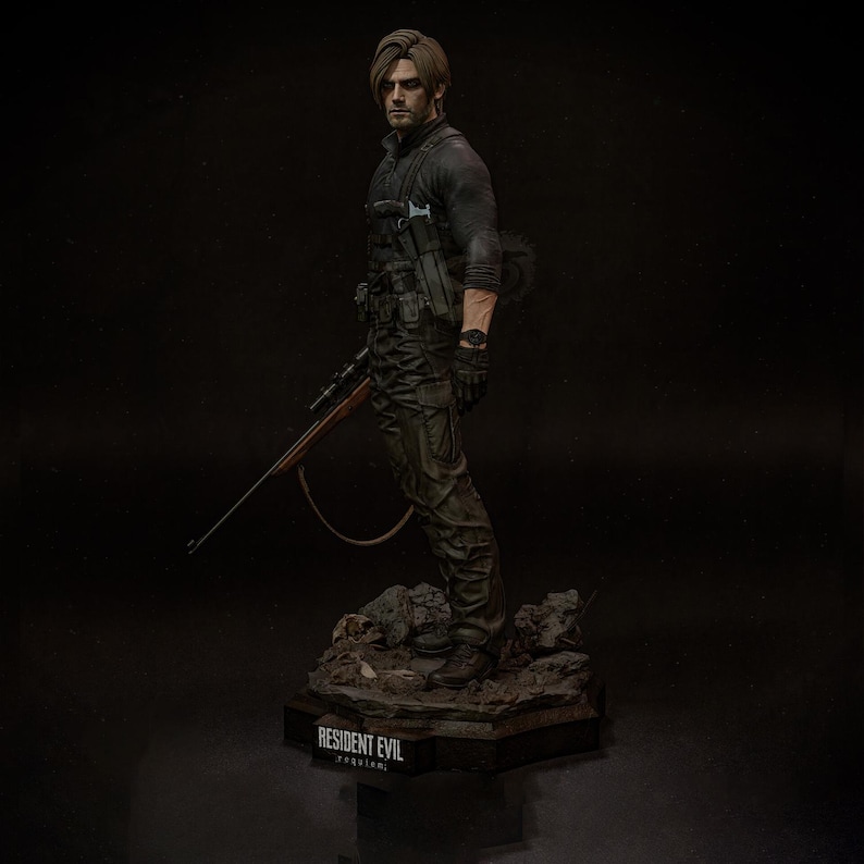 May include: A detailed figurine of a character from Resident Evil, posed with a rifle. The figure is dressed in tactical gear, with a black long-sleeve shirt and camouflage pants. The base of the figure has the text "RESIDENT EVIL" and "requiem".