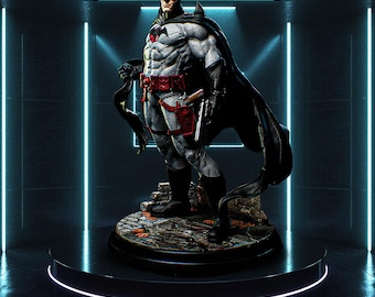 May include: A detailed Batman statue in a dynamic pose, featuring a gray and black suit with red accents on the belt and holster. The figure stands on a rocky base, with a black cape flowing behind it. The statue is displayed on a black pedestal.