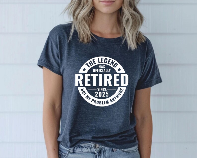 May include: A dark blue t-shirt with a white circle graphic that says "The Legend Has Officially Retired Since 2025 Not My Problem Anymore".