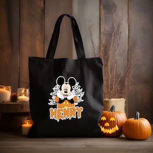 May include: Black canvas tote bag with a Mickey Mouse character dressed as a pumpkin. The bag has the name "HENRY" printed in orange dripping letters.