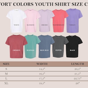 May include: Youth shirt size chart with measurements in inches. The chart shows different colors of shirts, including white, blossom, orchid, watermelon, violet, crimson, seafoam, blue jean, pepper, and black.