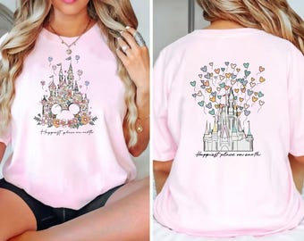 May include: Pink t-shirt with a floral design of Cinderella's castle and the text "Happiest place on earth". The back of the shirt features the same castle design with colorful balloons.