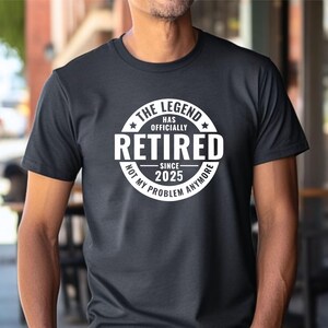 May include: Black t-shirt with a white circle graphic that says "The Legend Has Officially Retired Since 2025 Not My Problem Anymore".