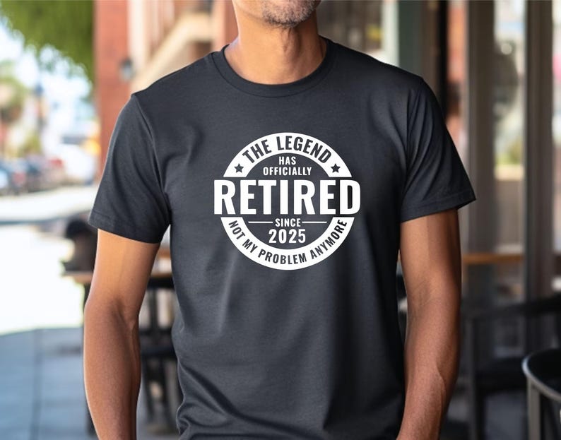 May include: Black t-shirt with a white circle graphic that says "The Legend Has Officially Retired Since 2025 Not My Problem Anymore".