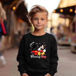 May include: Black sweatshirt with a Mickey Mouse design and the text "Name 4 Birthday Boy".