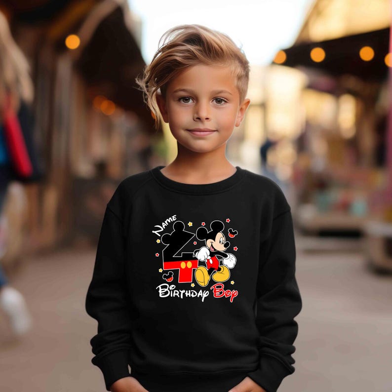 May include: Black sweatshirt with a Mickey Mouse design and the text "Name 4 Birthday Boy".