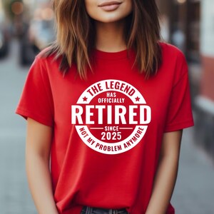 May include: Red t-shirt with a white circle graphic that says "The Legend Has Officially Retired Since 2025 Not My Problem Anymore".