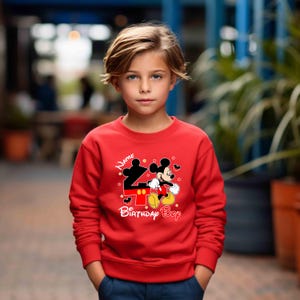 May include: Red sweatshirt with a Mickey Mouse graphic and the text "Name Birthday Boy".
