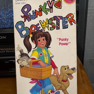 May include: A vintage VHS tape for "Punky Brewster" home video. The cover features a cartoon illustration of Punky, a dog, and a monkey. The title is in colorful, playful lettering. The tape is labeled "Fully Animated" and has a runtime of 45 minutes.