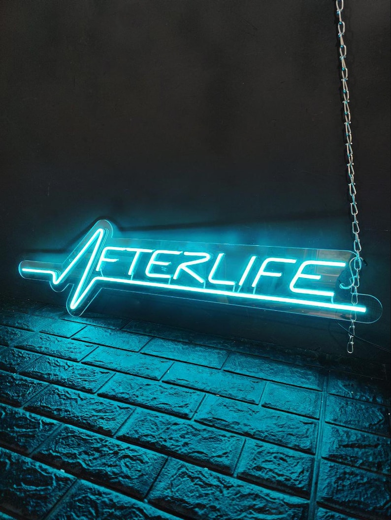 Afterlife LED neon sign for game room decor, bedroom wall art, or bar ambiance. This light-up sign captures a sleek cyberpunk aesthetic, making it an ideal gift for fans of Cyberpunk 2077 or modern sci-fi design. Perfect for man caves, gaming setups