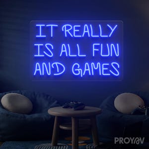 Typography LED wall art with It Really Is All Fun and Games phrase, suitable for bars and lounge interiors, enhancing atmosphere with humor and playful personality.