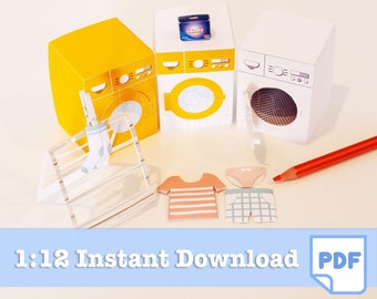 May include: A miniature laundry room scene with three paper washing machines in yellow, white, and off-white. Includes paper clothing, a drying rack, and a red pencil. The text "1:12 Instant Download PDF" is at the bottom.