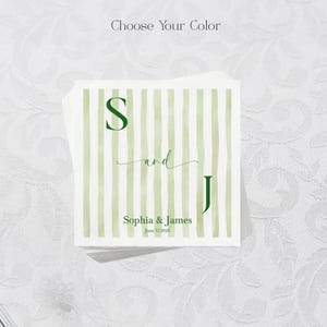 May include: A square paper napkin featuring a light green watercolor striped pattern. The text reads Choose Your Color at the top, with the letters S and J, the word and, and the names Sophia & James with the date June 17, 2026 printed in dark green.