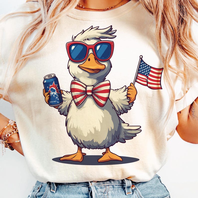 May include: A white t-shirt with a cartoon duck wearing sunglasses, a red, white, and blue bow tie, and holding a can of soda and a small American flag.